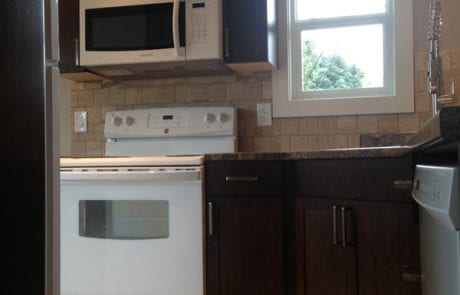 completed apartment renovation - kitchen travertine tile