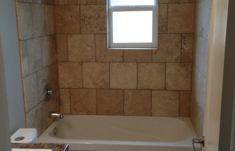 completed apartment renovation - bathroom with travertine tile