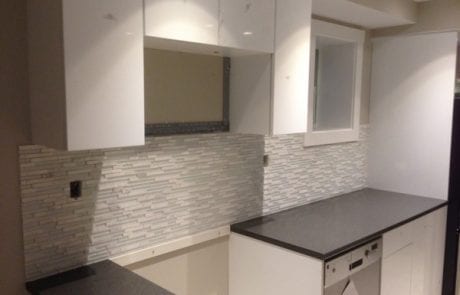 apartment renovation - white kitchen, glass tile back-splash