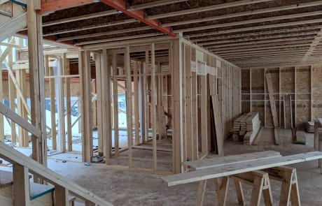 Construction site of custom home main floor during framing