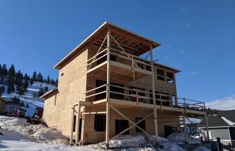 back of custom home in winter at lockup stage