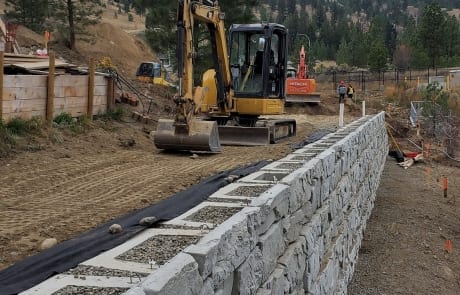 Excavator grading after Verti-Block Retaining wall installation